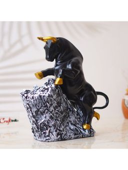 eCraftIndia - Black Polyresin Bull Statue with Golden Horns, Climbing on Rock Showpiece