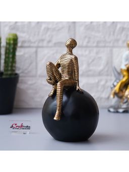 eCraftIndia - Golden Boy Statue Sitting on Black Ball Human Figurine Decorative Showpiece