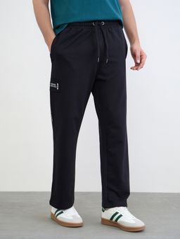 Styli - Men Placement Printed And Applique Patch Oversized Track Pants