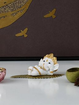 At Home by Nilkamal - Ganesha On Leaf Polyresin Showpiece (White & Gold)