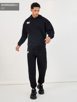Styli - Men Black Patch Detail Fleece Oversized Co-Ord (Set of 2)