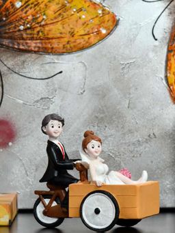 At Home by Nilkamal - Couple On Cart Showpiece Multi Color