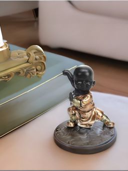 At Home by Nilkamal - Baby Monk Holding Stick Showpiece Rose Gold