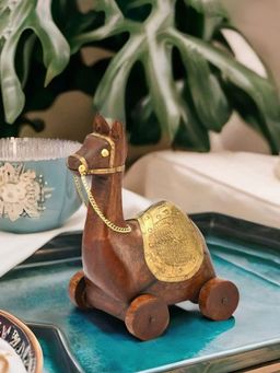 At Home by Nilkamal - Camel Sitting On Wheel Wooden Showpiece Brown & Gold