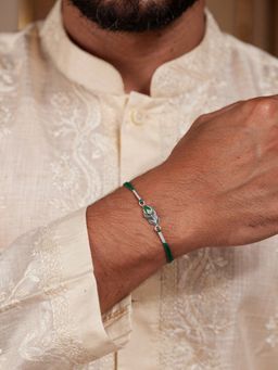 Ornate Jewels - 925 Silver Rhodium Plated Peacock Feather Thread Rakhi With Roli Chawal