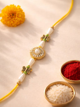 Karatcart - Gold Plated White Pearl and Butterfly Charm Bhaiya Kundan Rakhi with Roli Chawal