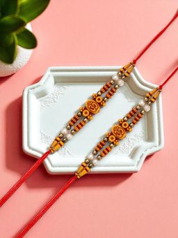 ADIVA - Pack Of 2 Om Symbol Cz Stone & Beads Thread Rakhi With Thali Roli Chawal Bag Gift Set
