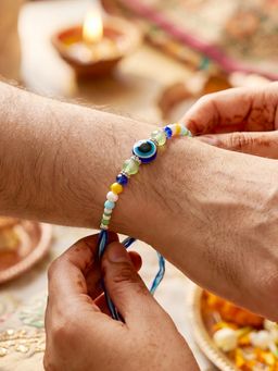 LUCKY JEWELLERY - Blue Evil Eye Rakhi with Greeting Card and Roli Chawal Set for Raksha Bandhan