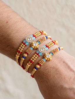 LUCKY JEWELLERY - Designer Rakhi with Small Crystal Floral Centrepieces, Gold-Tone Beads (Pack of 4)