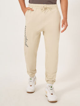 Styli - Men Slogan Print Beige Oversized Fit Cotton Terry Joggers