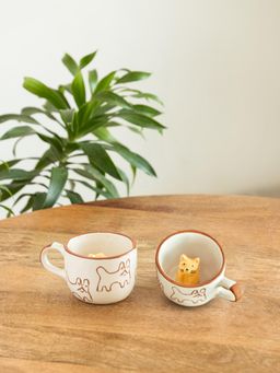 ExclusiveLane - Hand-Embossed Cute Cat Suprise Ceramic Tea & Coffee Mugs (Pack of 2)