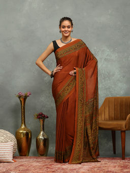 MEENA BAZAAR - Printed Rust Crepe Saree With Unstitched Blouse