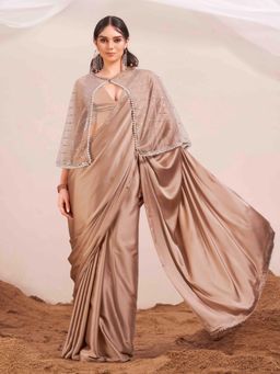 Tikhi Imli - Beige Colored Satin Saree with Unstitched Blouse and Embellished Cape