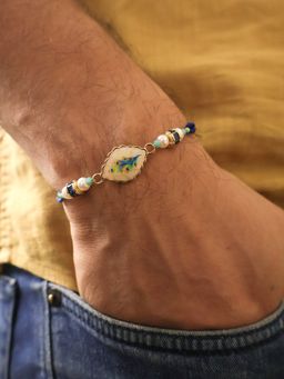 BeAbhika - Blue Peacock Pearl Charm Rakhi With Roli Chawal Capsules