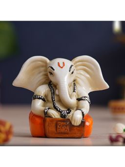 eCraftIndia - White Orange Polyresin Lord Ganesha Idol Playing Harmonium Musical Instrument
