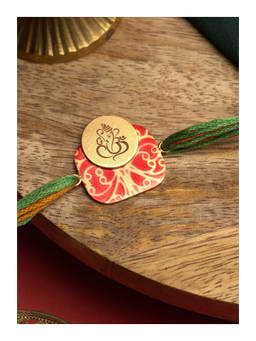 Suhani Pittie - Divine 22K Gold Plated Hand Painted Ganesh Rakhi With Green And Orange Tieups