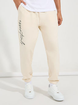 Styli - Men Cream Relaxed Fit Typography Joggers with Slant Pocket
