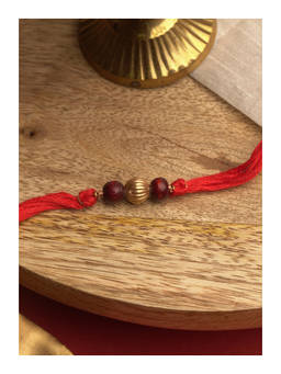 Suhani Pittie - Precious Chandan Beads 22K Gold Plated Rakhi With Red Tieups