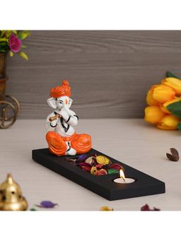 eCraftIndia - Polyresin Ganesha Playing Flute Showpiece with wooden Base, Petals & Tealight