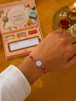 SAMIKA - 999 Pure Silver Swastik Coin Rakhi Hamper with Mukhwas, Roli and Chawal