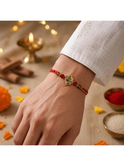 SHILLYN - Antique Gold Peacock Feather Designer Rakhi In Festive Red