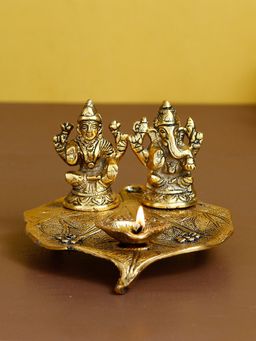 eCraftIndia - Golden Lakshmi Ganesha Idol Decorative Diya On Leaf Diya