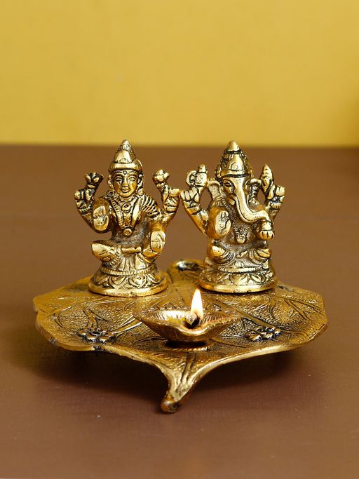 eCraftIndia Golden Lakshmi Ganesha Idol Decorative Diya On Leaf Diya
