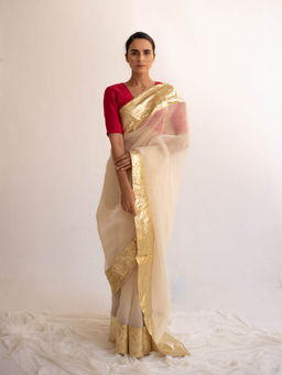 KAPARDARA - A Pure Silk Organza Saree In The Shade Of Cream Handcrafted With Gold Lampe Border