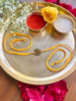 Studio Anviksha - Yellow Circular Hammered Brass Rakhi