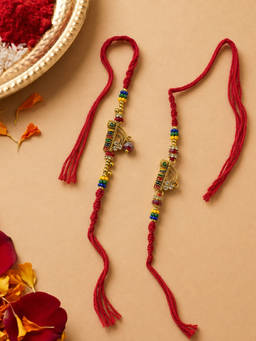 Niscka - Gold Plated Krishna Flute Bhaiya Bhabhi Rakhi Set (Pack of 2)