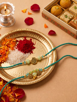 Niscka - Gold Plated Om Krishna Bhaiya Bhabhi Rakhi Set (Pack of 2)